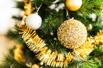 christmas tree with gold and silver decorations including stars and tinsel