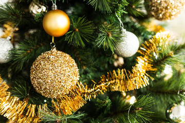 christmas tree with gold and silver decorations including stars and tinsel
