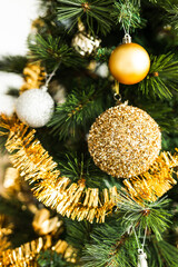 christmas tree with gold and silver decorations including stars and tinsel