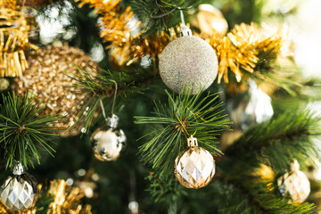 christmas tree with gold and silver decorations including stars and tinsel