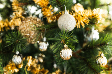 christmas tree with gold and silver decorations including stars and tinsel
