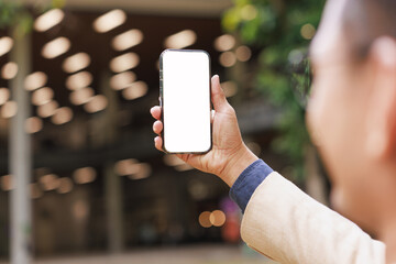 Man holding smartphone with white screen mockup outdoors