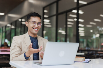 Asian man leading online video business meeting