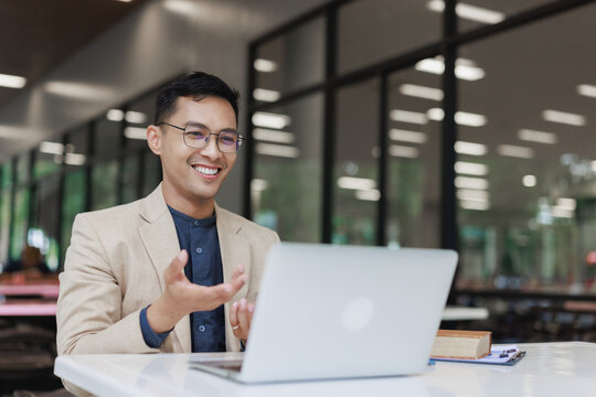Asian man leading online video business meeting - Powered by Adobe