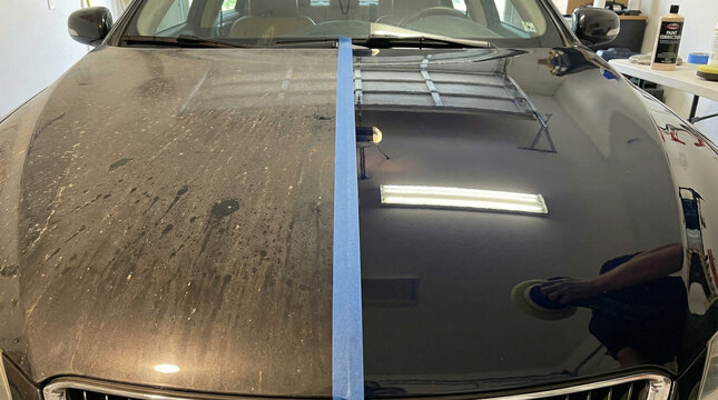Car hood showing a before and after comparison of paint correction with tape dividing the dirty and polished side