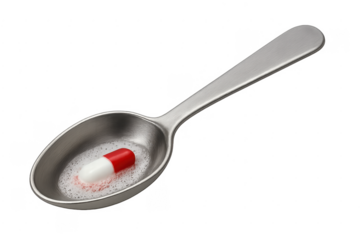 Capsule dissolving in a spoon of liquid