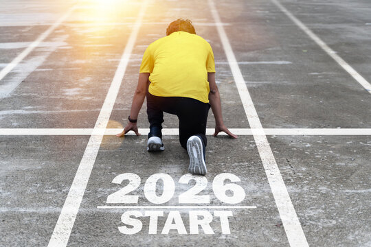 Man in starting position on track with 2026 start text, symbolizing new beginnings, goals, progress, and motivation