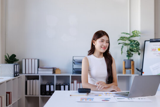 Young businesswoman analyzing data in modern office environment