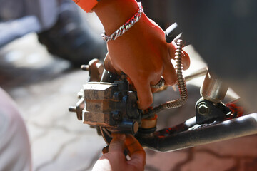 Close up of mechanic hand in focused concentration during an auto repair. worker performs vehicle maintenance and service work on metal brake part in garage