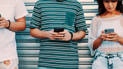 Hands, phone and typing with friends outdoor together for connection or social media browsing. App, contact and text message with group of people in line for communication, online chat or reading