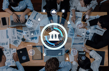 A dynamic group of professionals collaborates on financial planning and data analysis using modern technology in a contemporary office setting. Trope