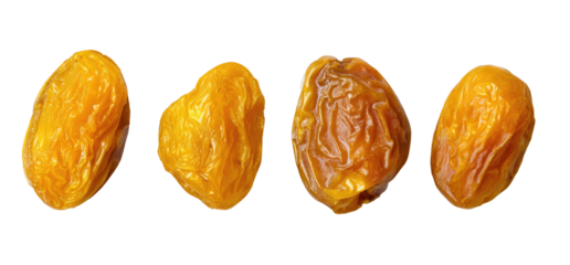 Four golden raisins on a black background, close-up
