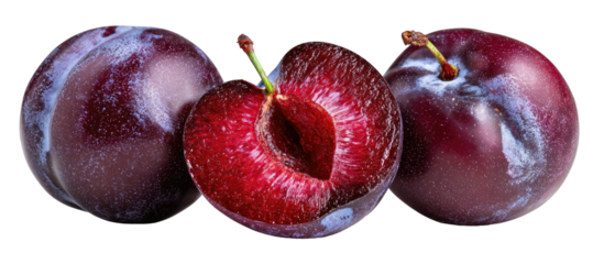 Fresh plums, one sliced open, showcasing vibrant red interior