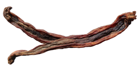 Two shriveled, brown, dried fruit pieces crossed on a black background