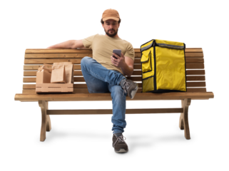 Food delivery man sitting on a bench using a smartphone