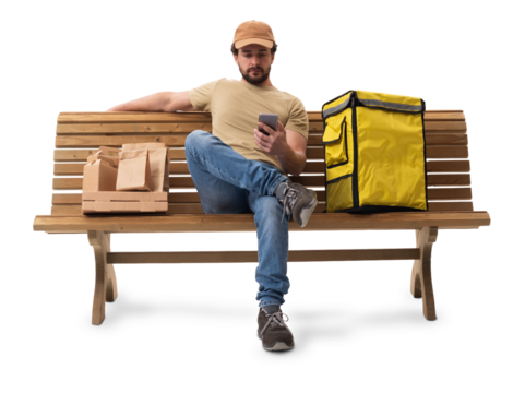 Food delivery man sitting on a bench using a smartphone
