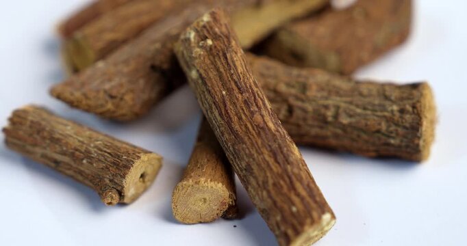 Ayurvedic Mulethi or Liquorice root stick or jeshthamadh powder served in a bowl over moody background