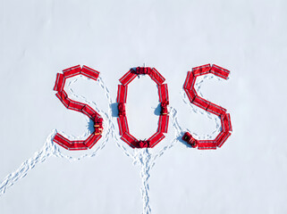 SOS distress signal on snow, a universal signal used to call for help.