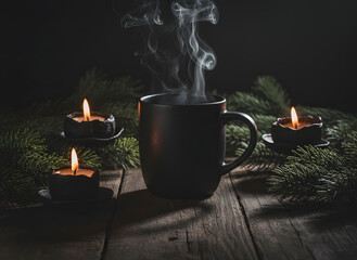 dark Christmas still-life, matte black mug with steam, pine branches in shadow