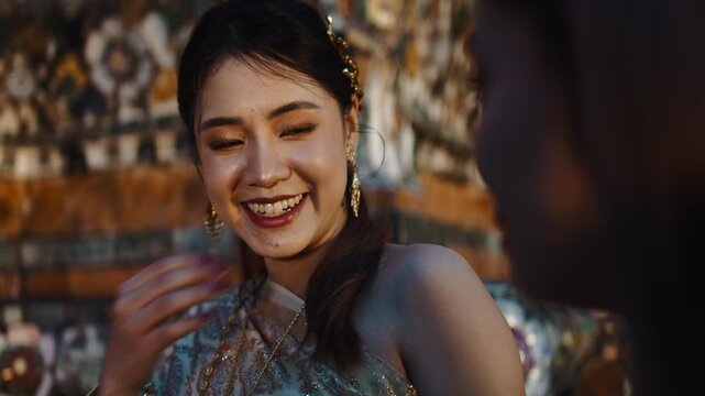Beautiful thai woman laughing at wat arun temple in bangkok