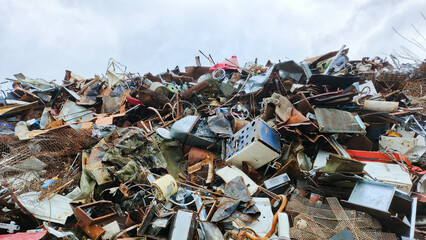 Piles of scrap metal lie in the open air. A collection point for illiquid metal.