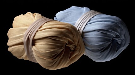 Soft Textiles in Warm Yellow and Cool Blue, Twisted Fabric Rolls on Dark Background for Textile and Fashion Projects