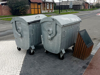 Outdoor Steel Waste Containers. Environmental Concept of Household Waste. Handheld Phone Photo, Selective Focus, No AI