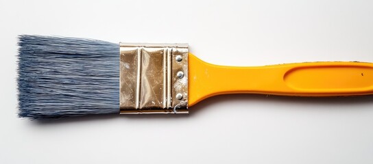 Blue-tipped paintbrush with yellow handle, close-up