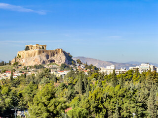 Fototapeta premium Acropolis of Athens above green cityscape in daylight