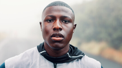 Exercise, portrait and sports with black man outdoor for cardio training, dedication or workout. Commitment, fitness and overcast with African runner in nature for activity, health or wellness