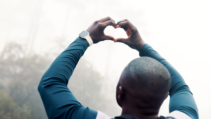 Black man, fitness and heart hands with mist in nature for outdoor training, health or wellness....