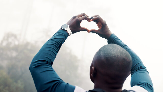 Black man, fitness and heart hands with mist in nature for outdoor training, health or wellness. Back view, active or male person in fog with emoji, sign or shape for love, exercise or winter workout