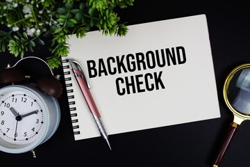Background Check text with alarm clock and magnifying glass