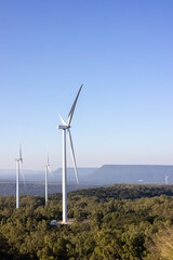 The landscape of a wind farm on top of a mountain.