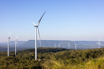 The landscape of a wind farm on top of a mountain.