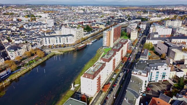 Le Mans cityscape, France in autumn, Sarthe river, autumn colors. Aerial drone forward