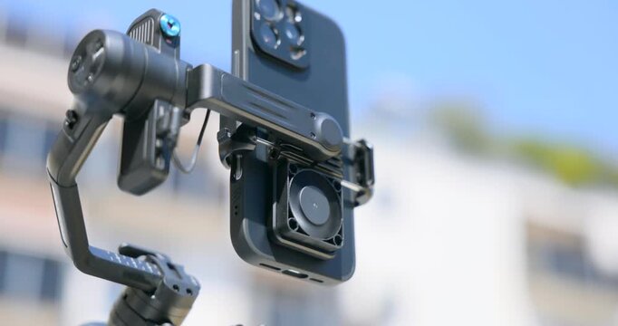 FeiyuTech SCORP Mini 3-Axis Gimbal Stabilizer With A Smartphone Attached. Close-up Shot