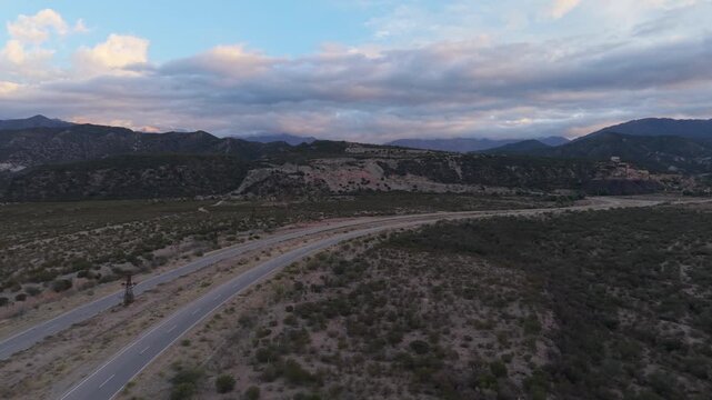 Av. la Mexicana curves through the landscape of Chilecito, La Rioja Province, Argentina, with dramatic mountains in the background.