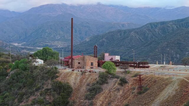 Historic mining complex and chimney at Estaci&oacute;n 2 Cable Carril, with mountains in Chilecito, La Rioja, Argentina.