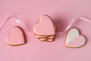 Heart shaped cookies with ribbon on pink background. Valentine's day celebration