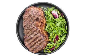 Grilled dry aged striploin steak with fresh arugula salad on a light textured background, juicy beef cooked to perfection for gourmet dishes