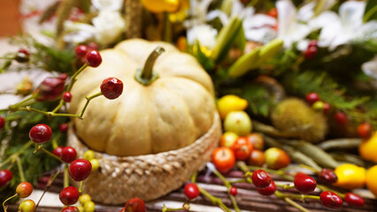 Colorful Thanksgiving centerpiece featuring chrysanthemums, gourds, and autumn fruits