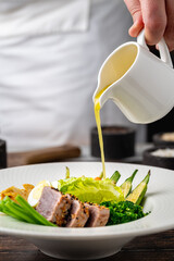 Fresh tuna salad with vegetables, eggs, and green greens