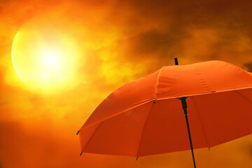 Closeup of red umbrella with sunset sky