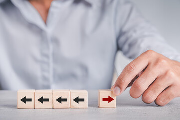 New ways of working, differentiation strategy concept symbol on wood blocks. Providing uniqueness, different and distinct from competitors, creating competitive advantage. Business direction concept.