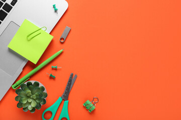 Composition with laptop, sticky notes and modern flash drive on orange background