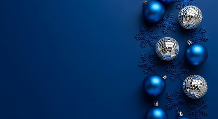 Festive blue christmas ornaments and tinsel on a dark blue background