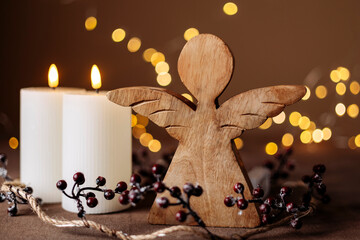 Fototapeta premium Advent white candles with decor in shiny lights closeup