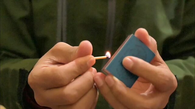 hand lighting a match, part 8