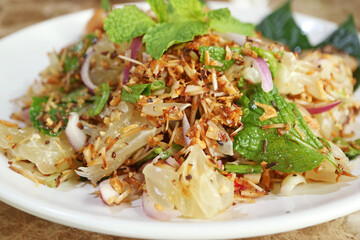 Closeup of Mouthwatering Spicy Pomelo Salad with Shallots and Roasted Grated Coconuts